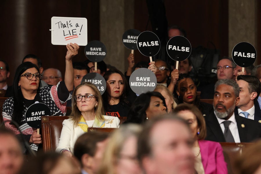 Democrats hold protest signs 