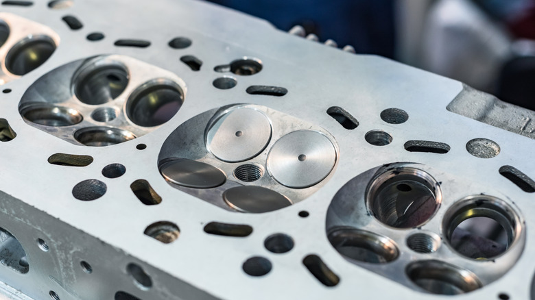 An open cylinder head of a car engine.