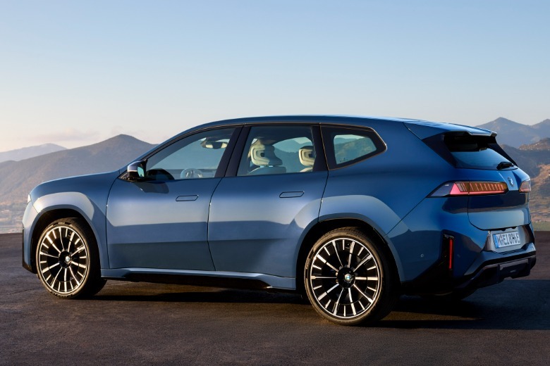 Rear 3/4 view of a blue 2026 BMW iX3