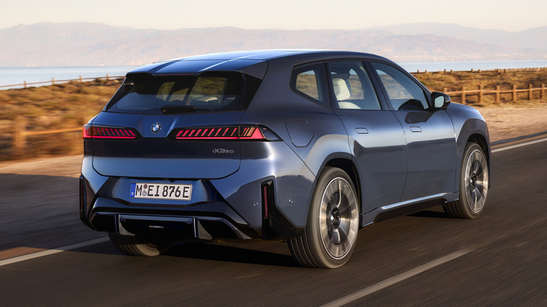 Rear 3/4 view of a blue 2026 BMW iX3
